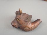 an image of a wooden pipe holder with a cat head on it
