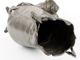 a metal object that is sitting on a white surface