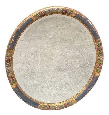 a round mirror with a floral design on it