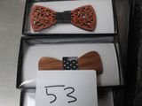 several wooden bow ties are lined up in a row with a price tag
