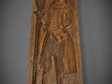 a wooden plaque with an image of a man holding a fish