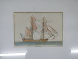 a drawing of a ship on display in a glass case