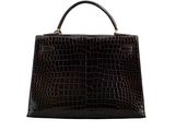 a brown crocodile skin handbag with a gold handle