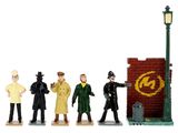 figurines of a group of people standing in front of a brick wall