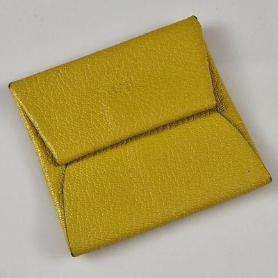 yellow leather business card case on a white surface