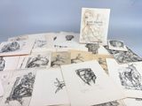 a pile of drawings on a table with a blue background