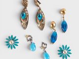 a set of five pairs of blue and gold earrings
