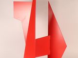 sculpture made of red metal on a white surface with a white background