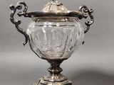 an antique silver plated glass jar with a lid on a stand