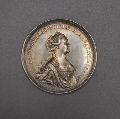 an old silver coin with a portrait of a woman on it