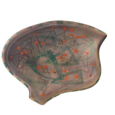 an image of a ceramic bowl with orange dots on it