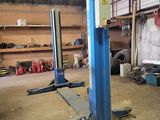 a picture of a man working on a vehicle in a garage
