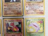 several pokemon cards are displayed on a white surface