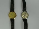 a couple of watches sitting next to each other on top of a table