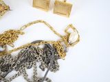 a lot of gold and silver jewelry on a white surface
