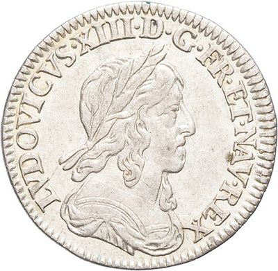 a silver coin with a woman ' s head on it