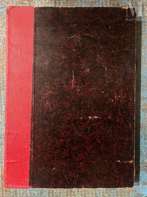 an old book sitting on top of a table next to a pair of scissors