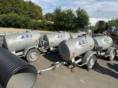 many different types of tanks lined up in a parking lot