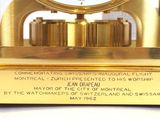 a gold clock that is sitting on top of a table