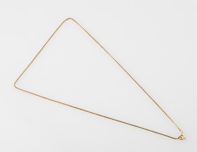 a gold necklace with a triangle shaped pendant on a white background