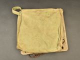 an old canvas bag with a handle on a table