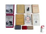 several books are sitting on a white surface with red covers