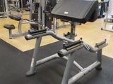 a gym room with machines and weights on the floor
