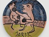 a plate with a drawing of a man and a dog on it