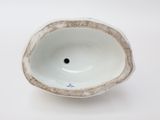 a small white bowl with a hole in the middle