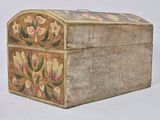 a small wooden box with a floral design on it
