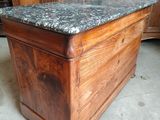 a wooden box with a granite top on the floor
