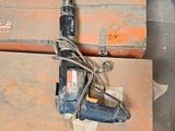 a drill and a hammer on a wooden table