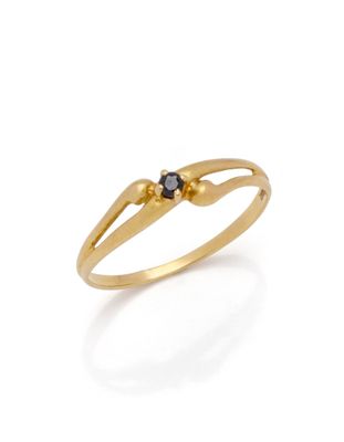 a close up of a gold ring with a black diamond