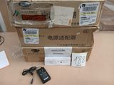 three boxes of electronic equipment sitting on a table