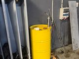 a yellow barrel sitting in the middle of a room