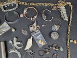 a lot of jewelry that is laying out on the table