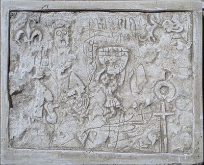 carvings on a wall of a building depicting a man and a woman