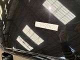 a reflection of a person in the rear window of a car
