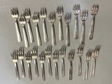 a lot of forks and spoons that are on the table