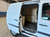a white van with its doors open in a garage