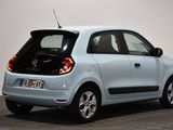 a picture of a small blue car parked in a room