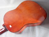 an orange guitar sitting on top of a white sheet