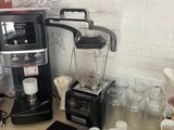 a coffee maker and a blender sitting on a counter