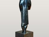 statue of a man standing on a pedestal with his back to the camera