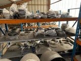 a lot of metal pipes on a shelf in a warehouse
