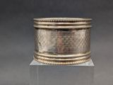 an image of a silver ring on a clear pedestal
