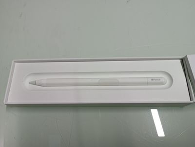 a white box with a pen in it on a table
