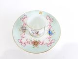 a cup and saucer on a saucer on a white table