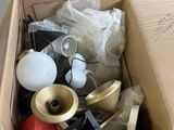 une boîte en carton remplie d'objets hétéroclites sur le sol
