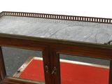 a wooden cabinet with a glass door on top of it